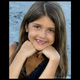 Little girl with chin resting on hands down by the beach